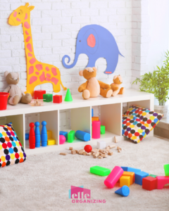 Playroom with colorful toys scattered in the foreground and a white storage bench behind.