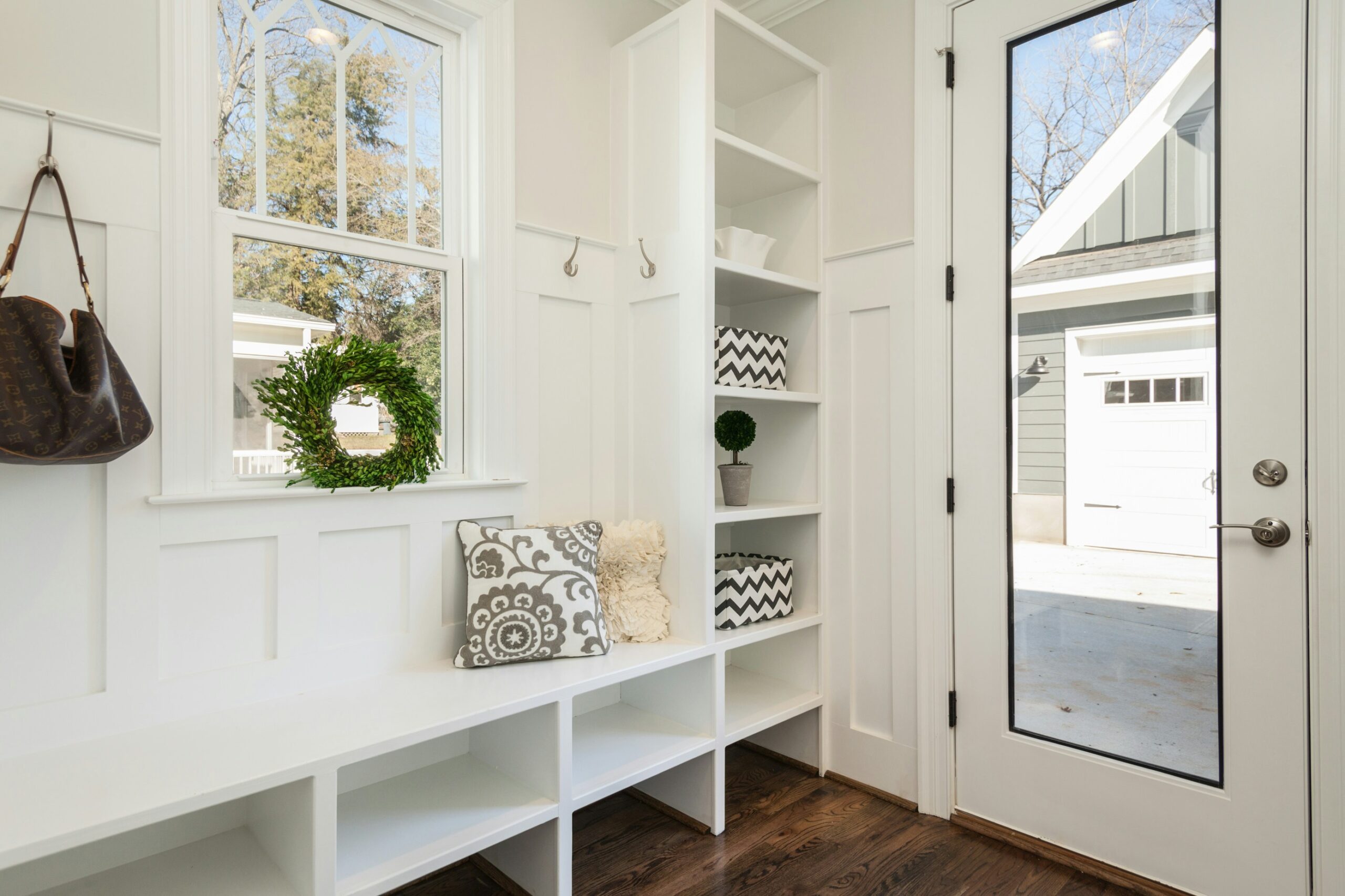 A bright, organized and welcoming entryway, foyer, or mudroom.