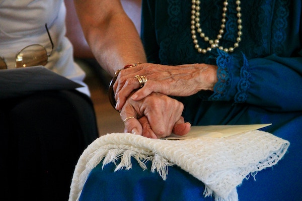 holding hands with aging parent
