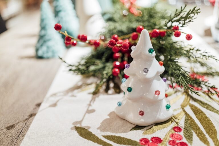 a small white christmas tree sitting on top of a table